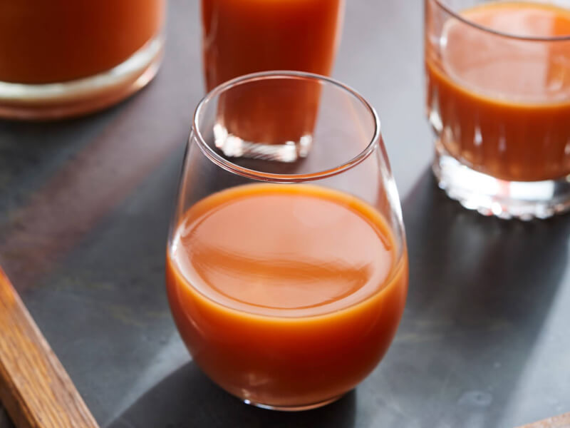 Orange and carrot juice in a stemless glass