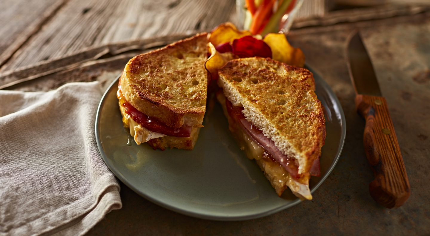 Syrupy ham French toast with fresh fruit on the side