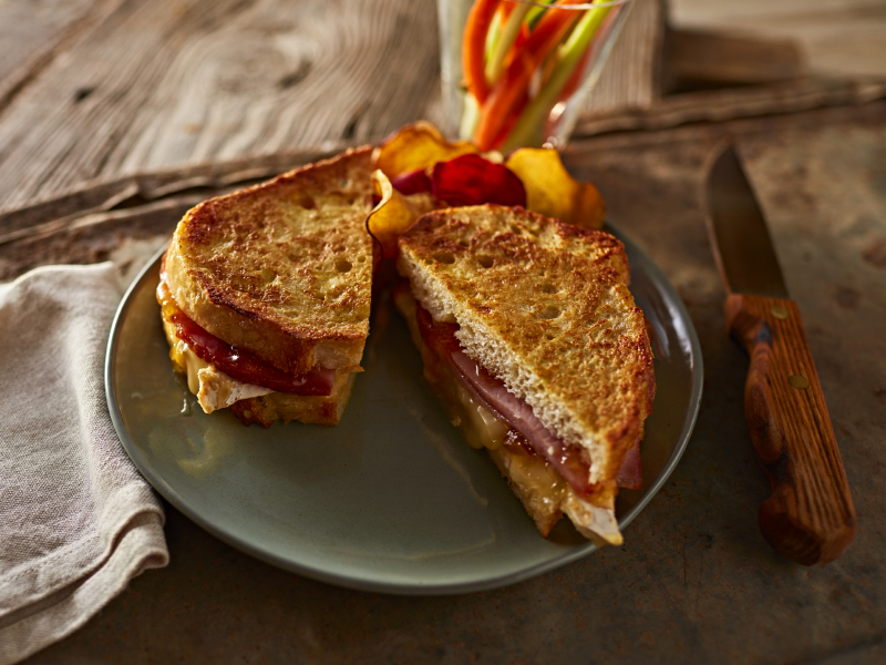 Syrupy ham French toast with fresh fruit on the side
