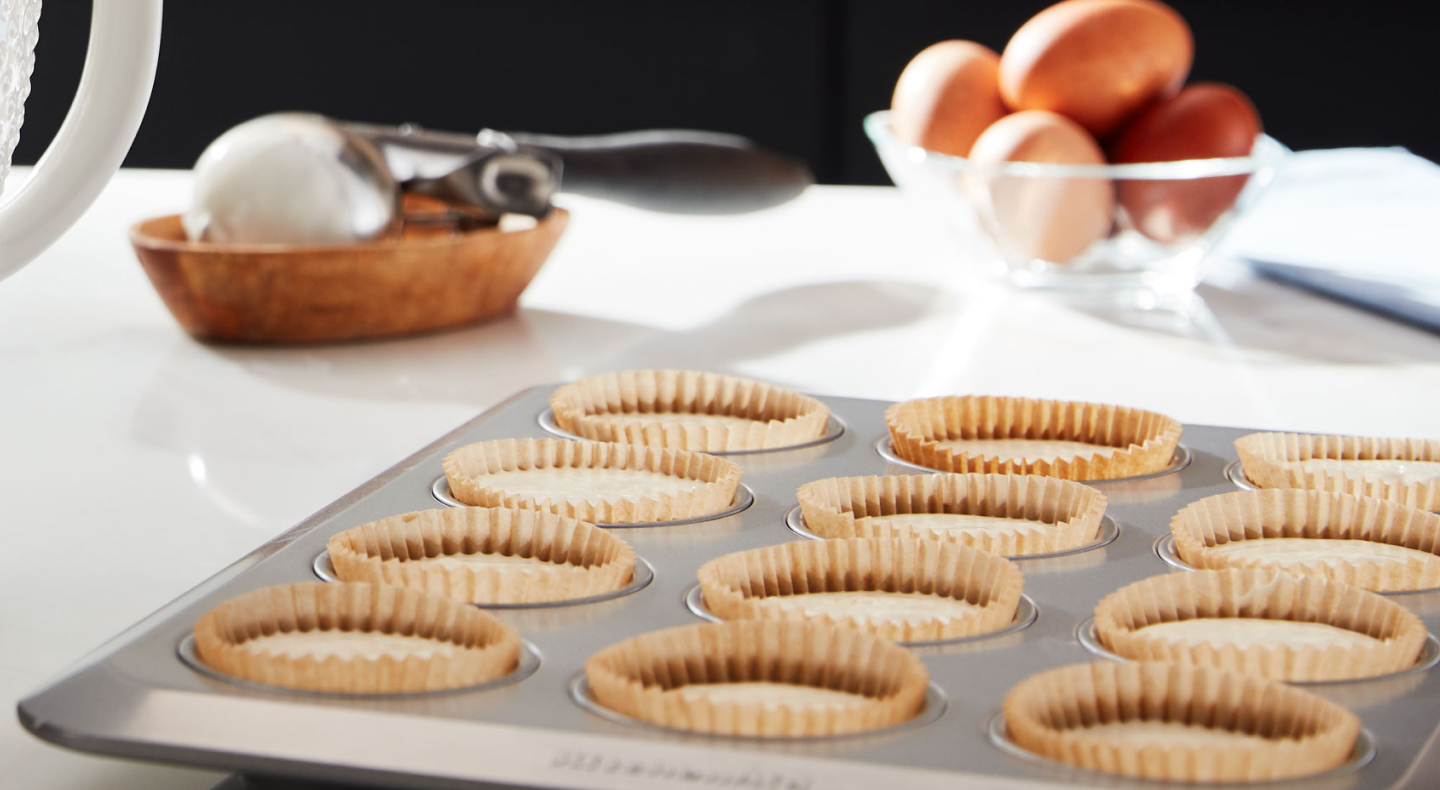 Close up of mini quiches in baking tray