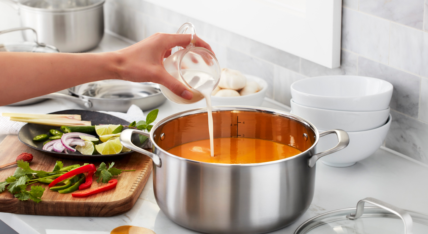 Person adding cream to a pot