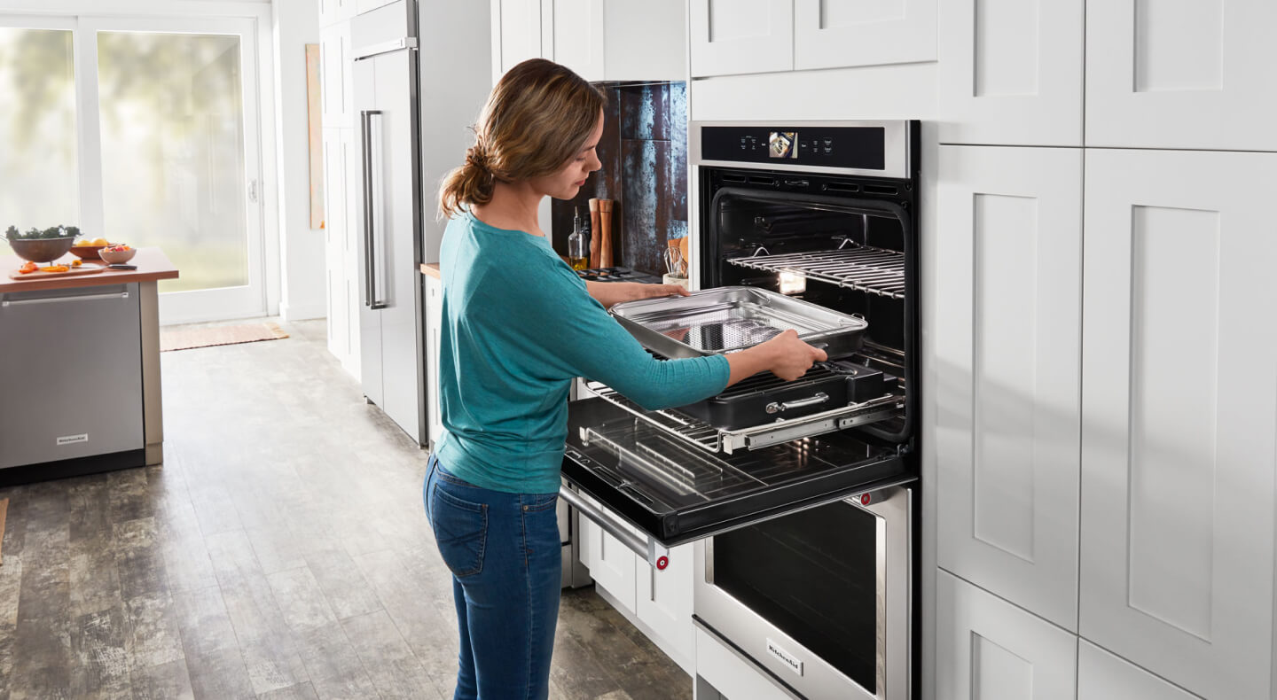 Person prepping their KitchenAid® oven to make ribs.