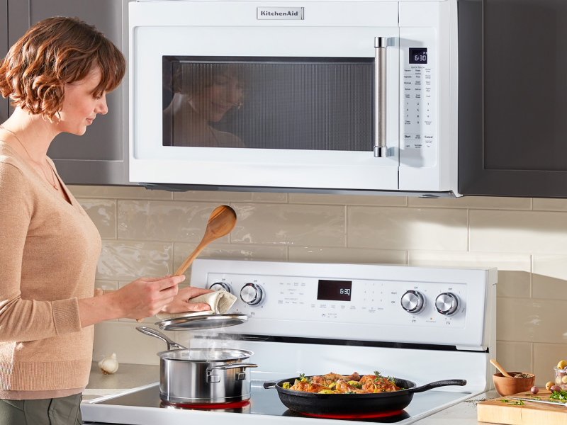 Woman cooking on a KitchenAid range