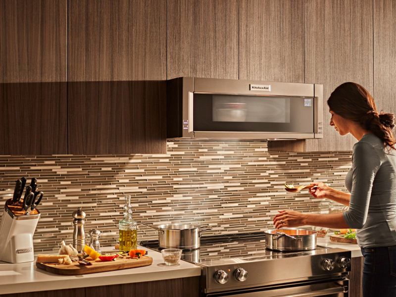 Woman cooking on a KitchenAid® electric range