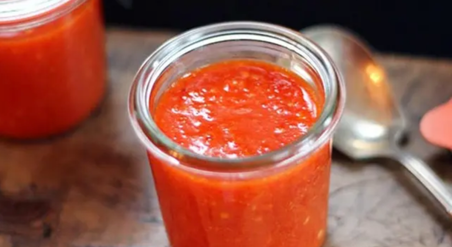Homemade sriracha in a glass jar