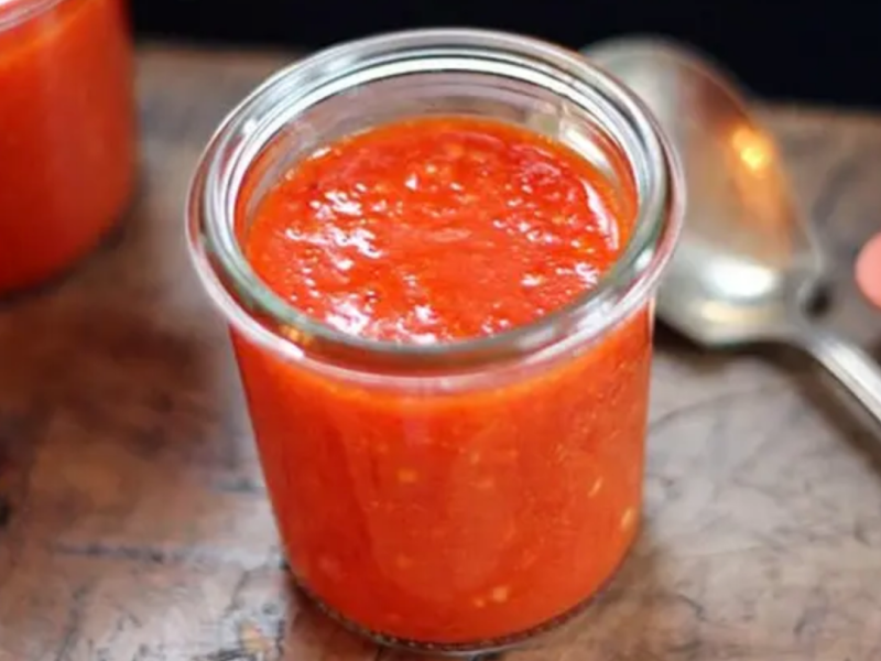 Homemade sriracha in a glass jar
