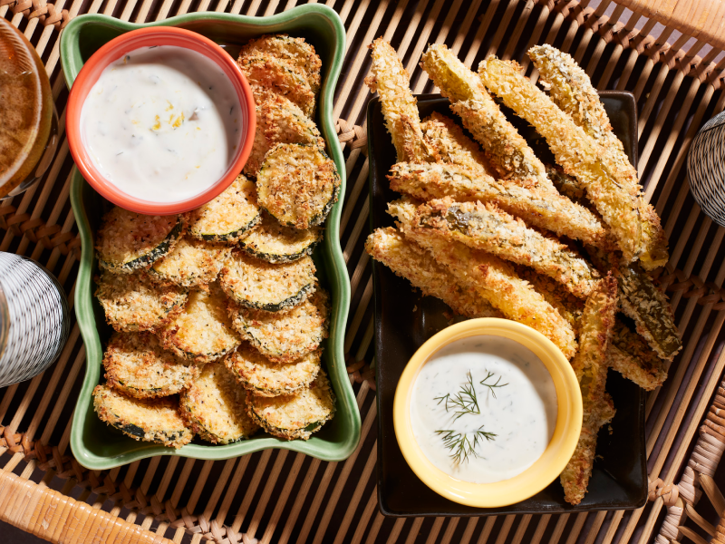 Plates of fried vegetables and dishes of vegan queso.