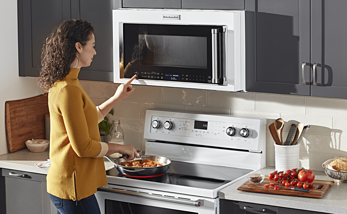 Person selecting a setting on a microwave