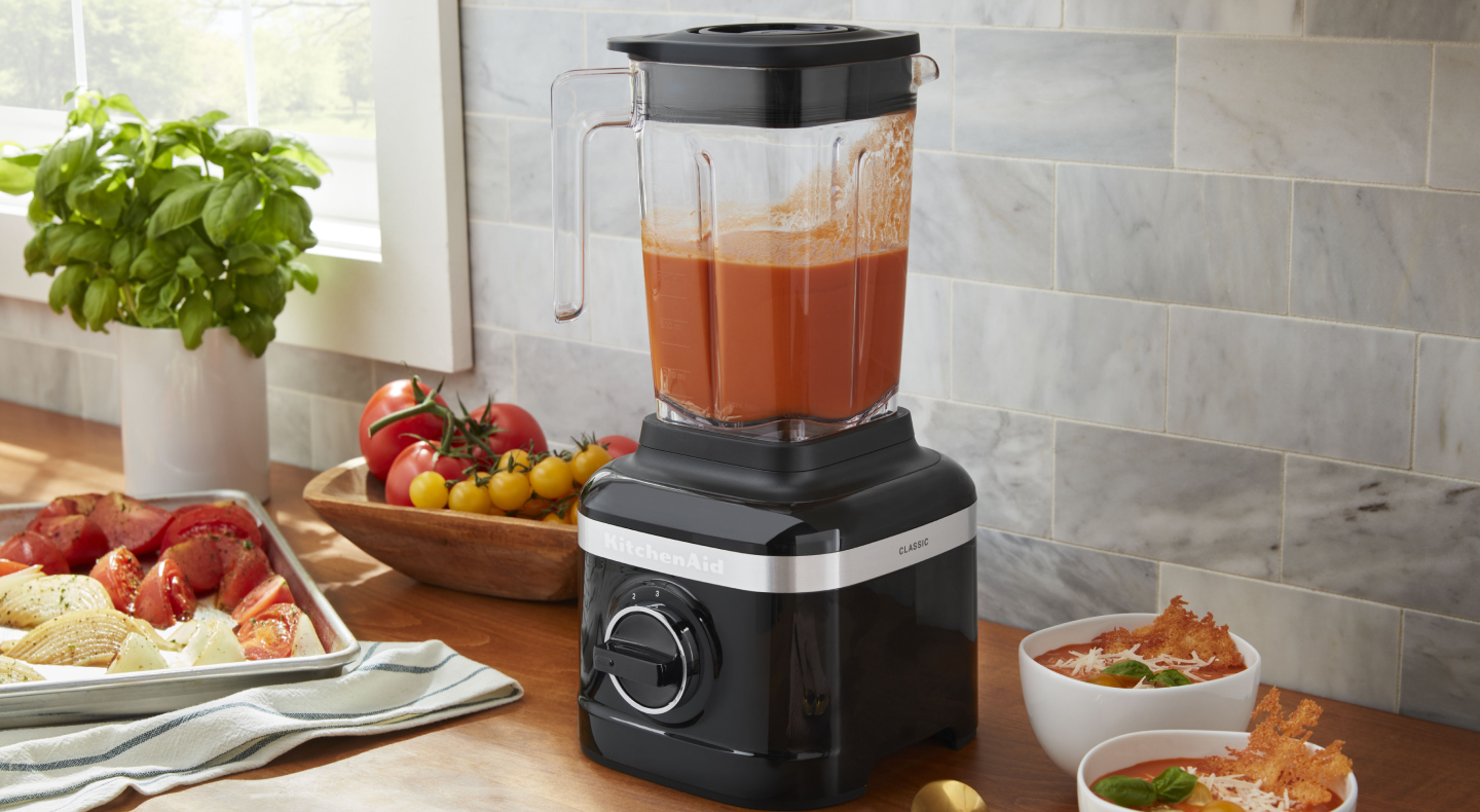 KitchenAid® blender filled with puree next to various ingredients