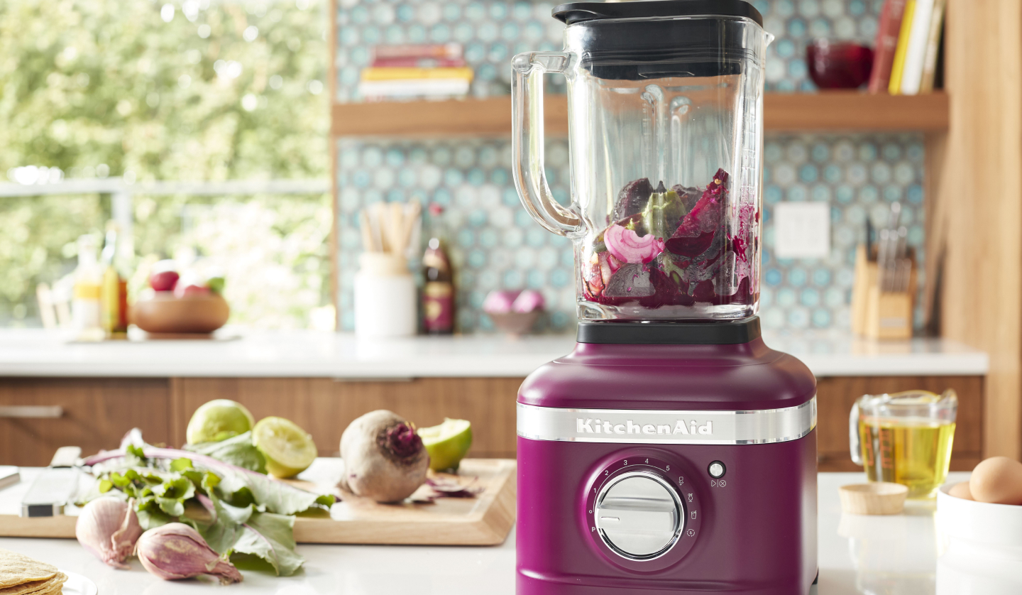 Beetroot KitchenAid® blender filled with various vegetables