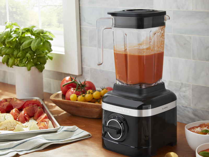 KitchenAid® blender filled with puree next to various ingredients