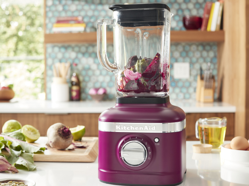 Beetroot KitchenAid® blender filled with various vegetables
