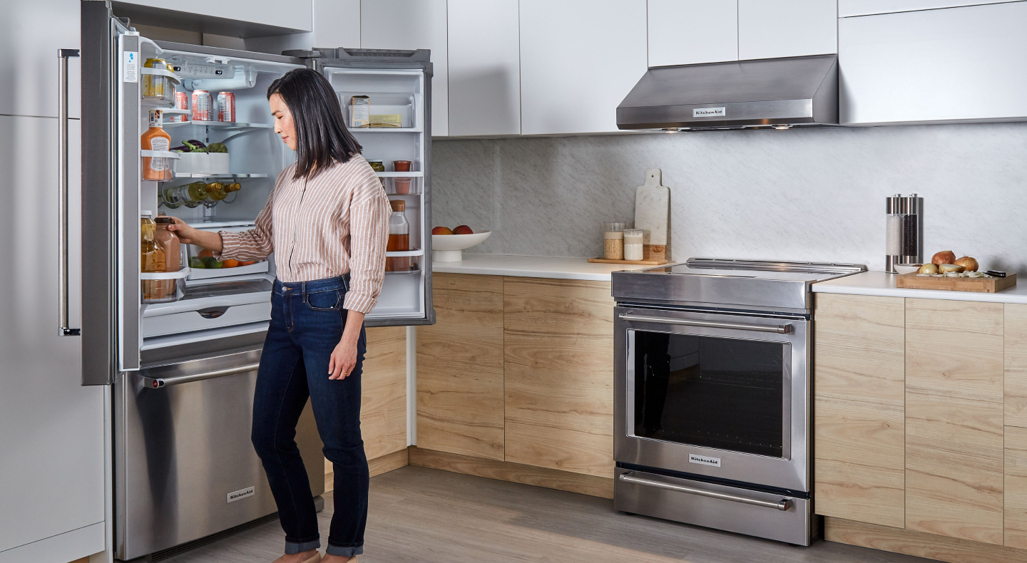 Person removing item from KitchenAid® refrigerator