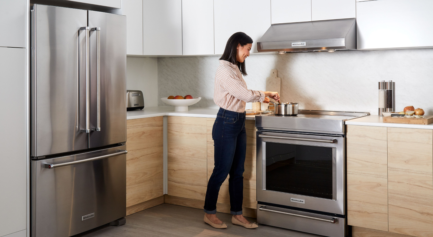 Person cooking at a KitchenAid® range
