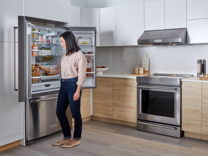 Person removing item from KitchenAid® refrigerator