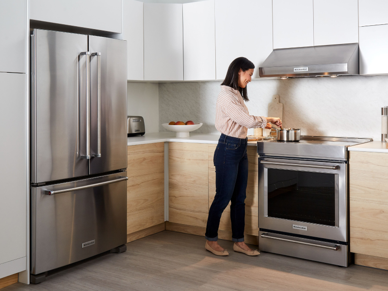 Person cooking at a KitchenAid® range