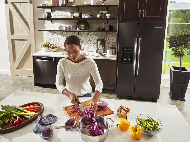 Person prepping ingredients in front of a refrigerator