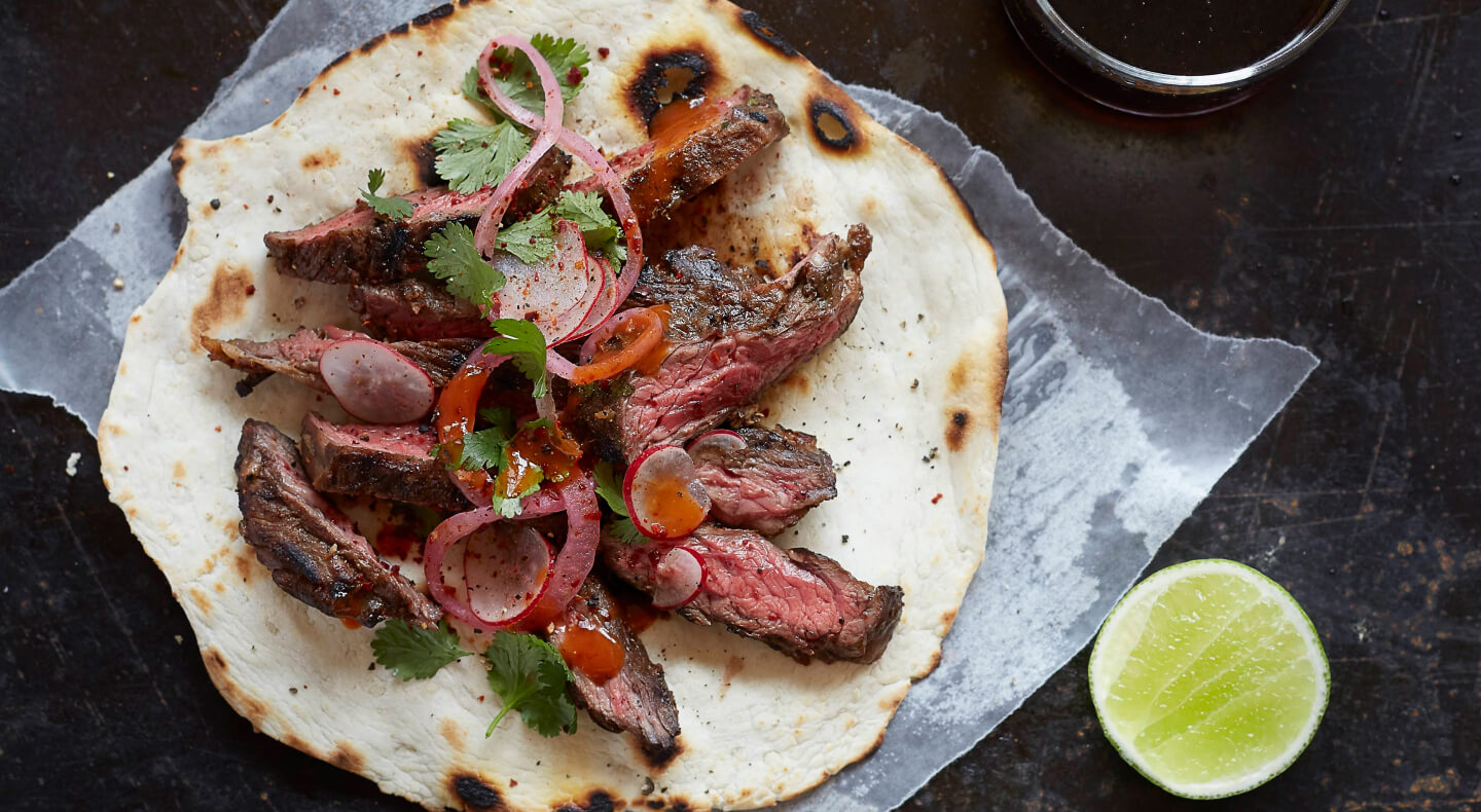 Sliced steak on a tortilla