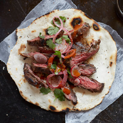 Sliced steak on a tortilla