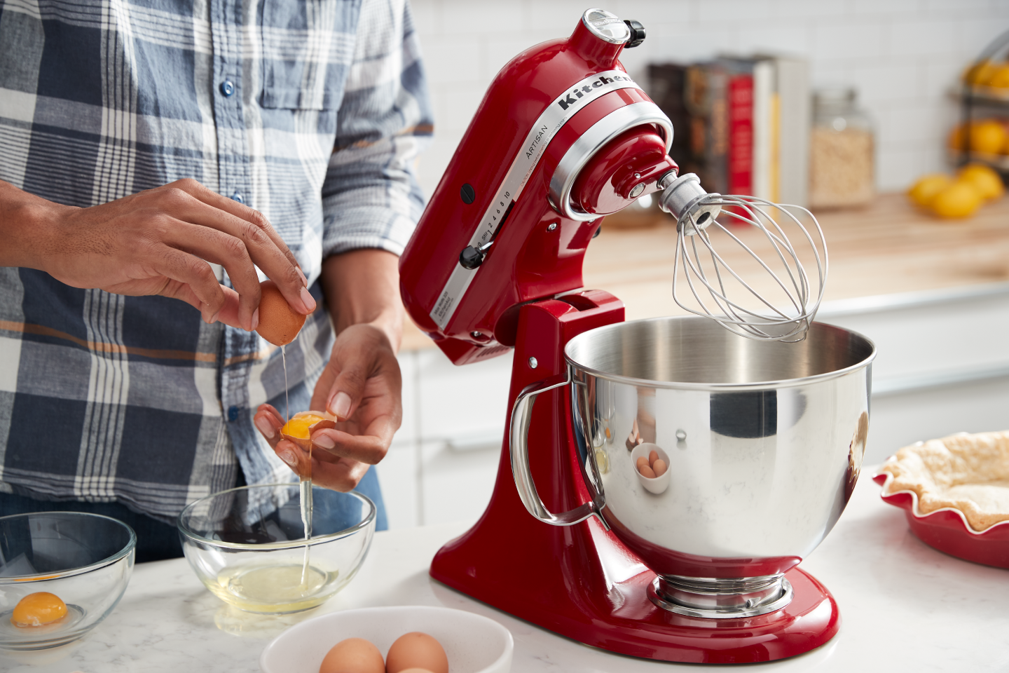 Hands slipping egg yolks between shells