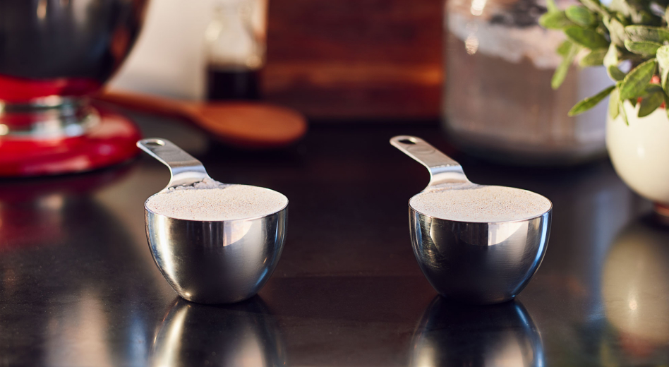  Two measuring cups filled with flour