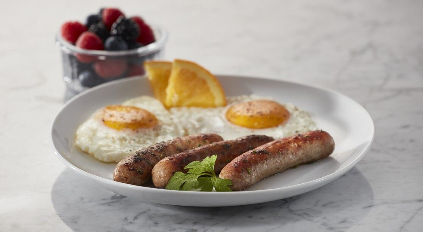 Sausages on a plate with eggs