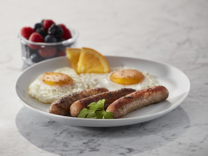 Sausages on a plate with eggs