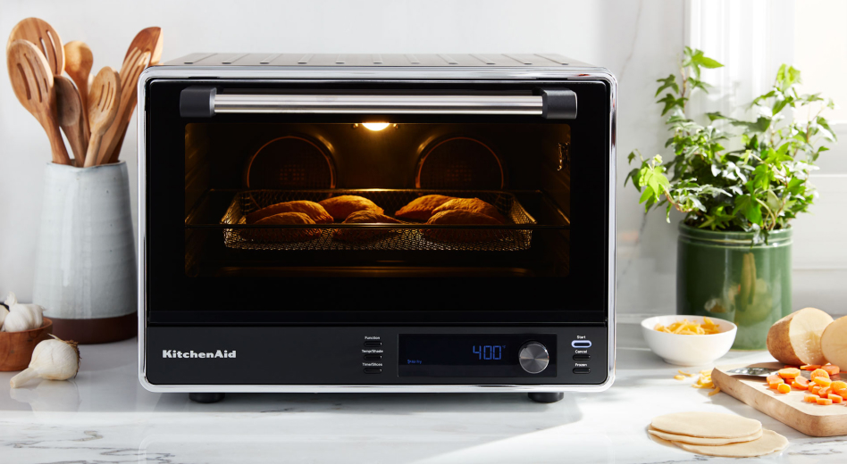 Empanadas cooking inside a black KitchenAid® countertop oven