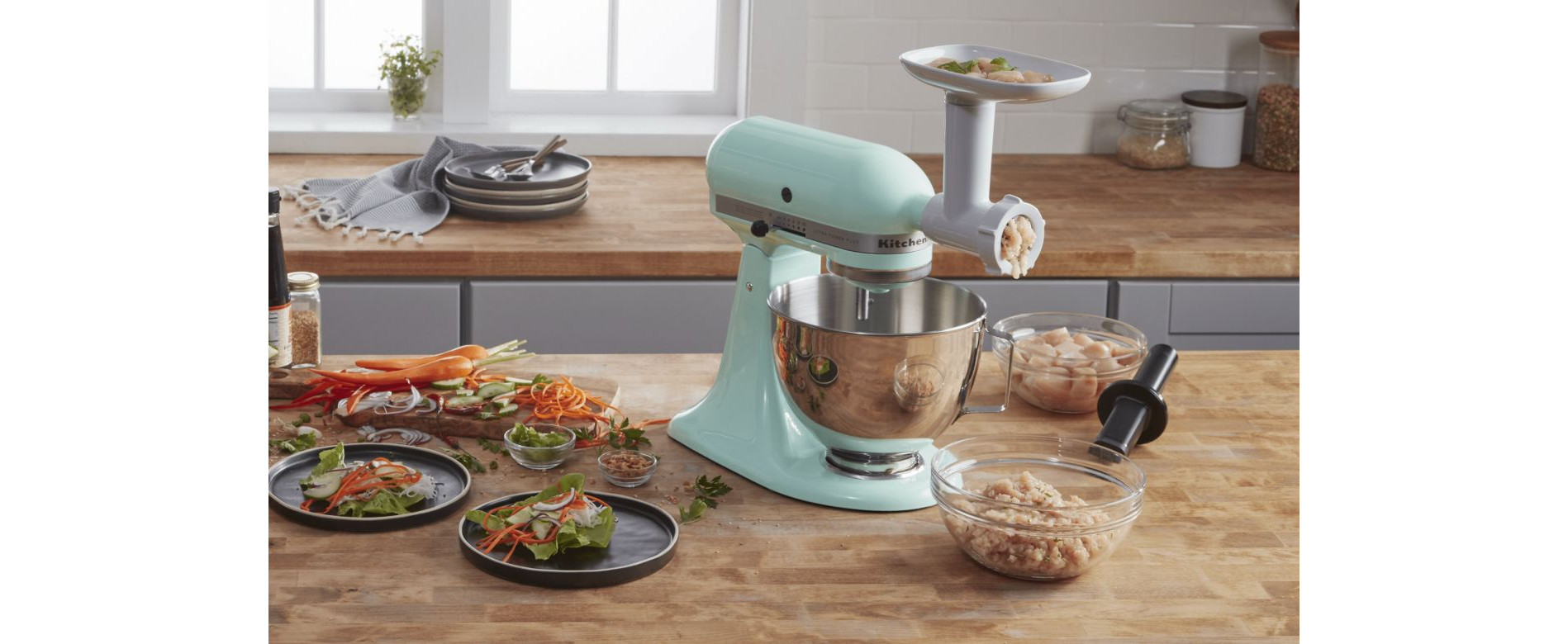 KitchenAid stand mixer with food grinder attachment grinding meat