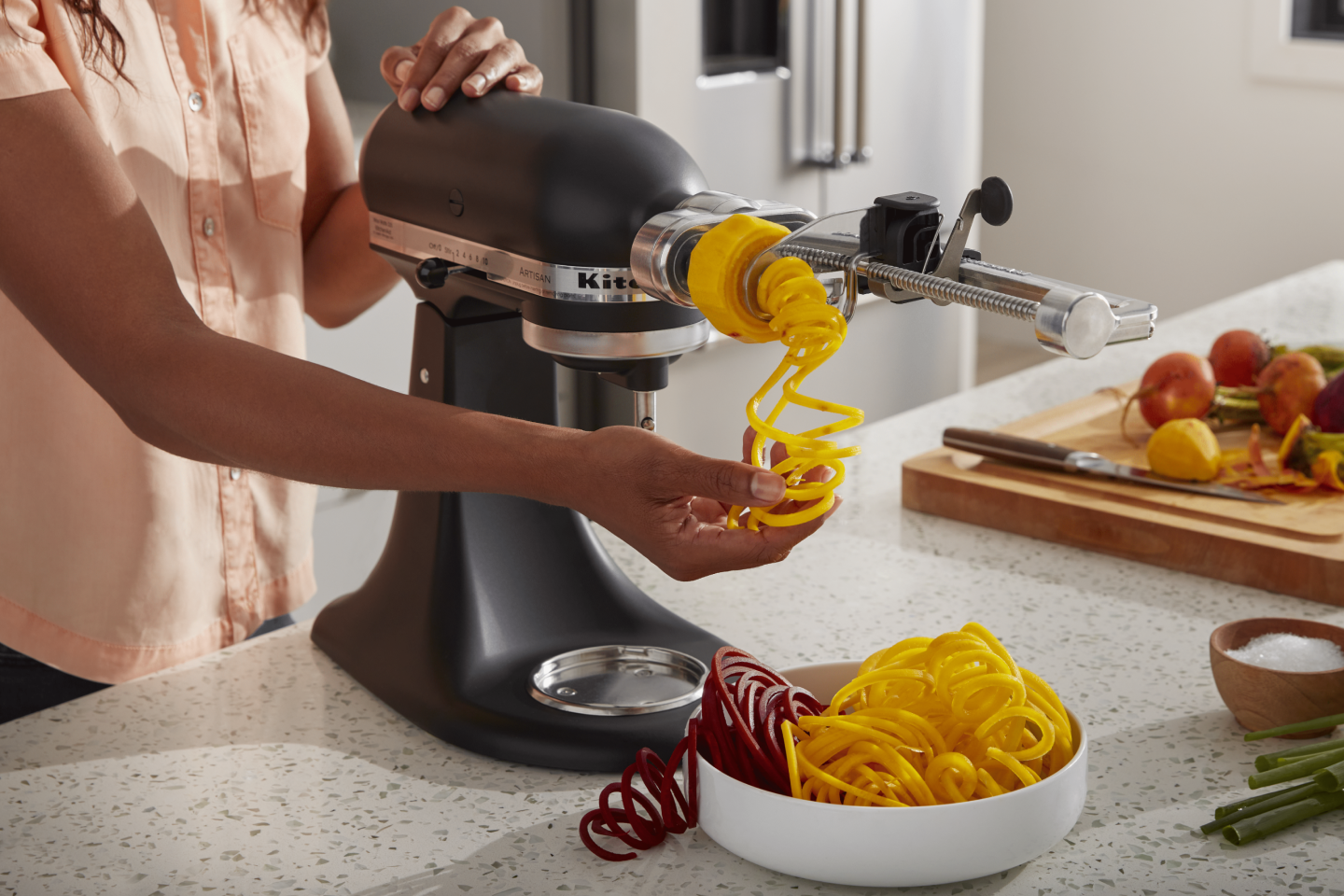 Yellow spiralized potatoes in a white bowl.