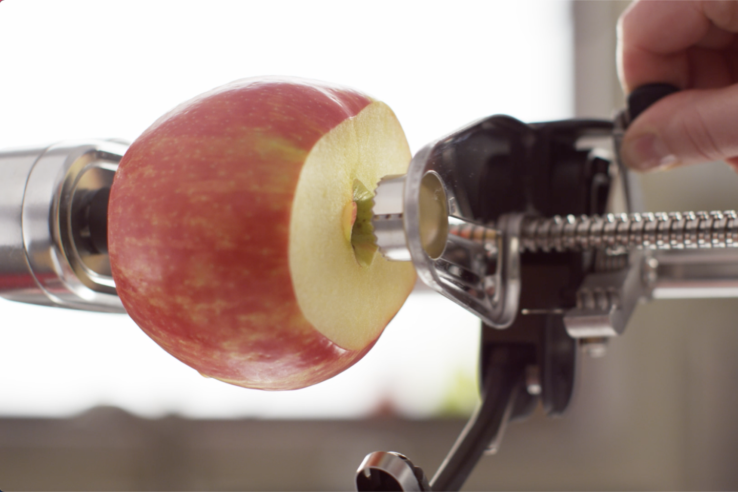 A person coring an apple.