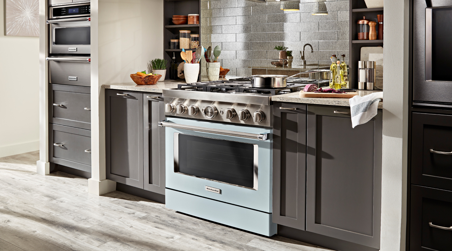 Blue KitchenAid® gas range installed in an updated kitchen