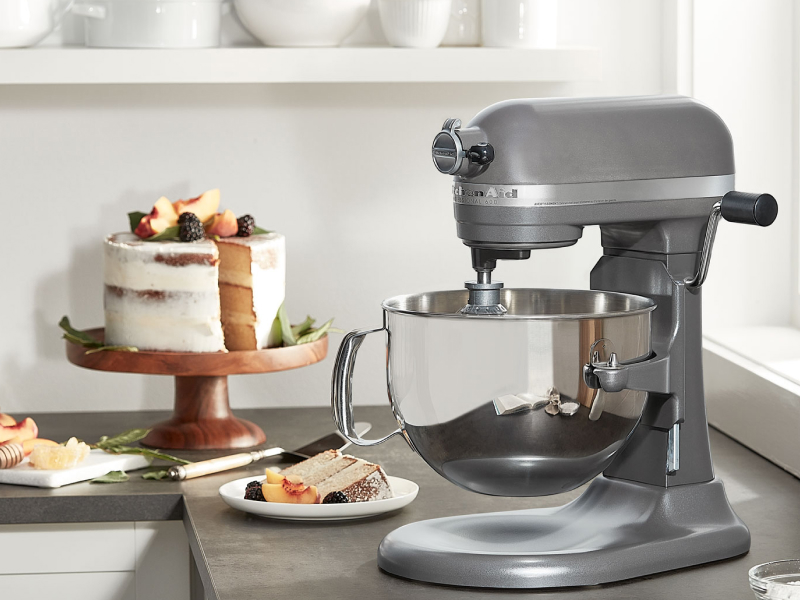 KitchenAid® bowl lift stand mixer next to layer cake on cake stand 