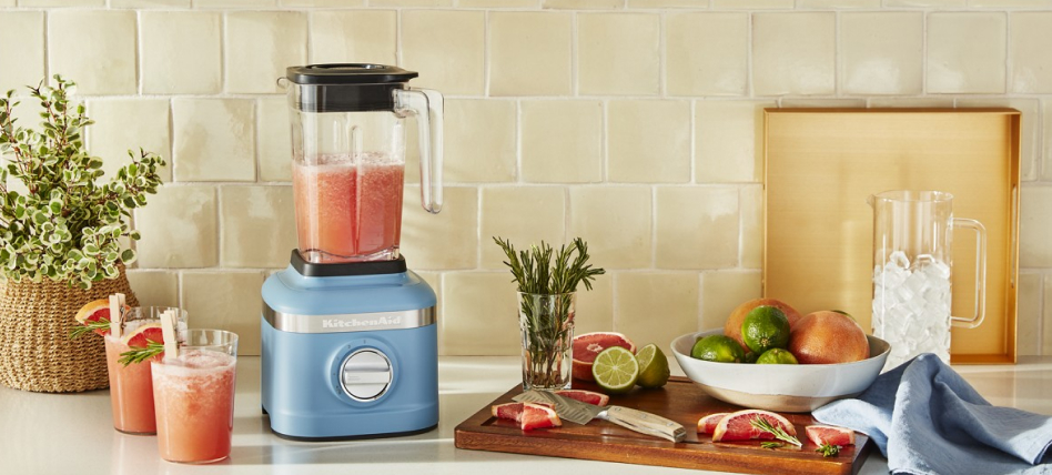 Blue velvet KitchenAid® blender with fruit and glasses of smoothies