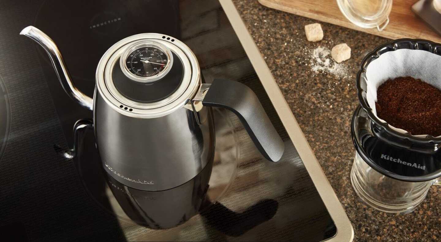 Gooseneck kettle next to pour over coffee maker 
