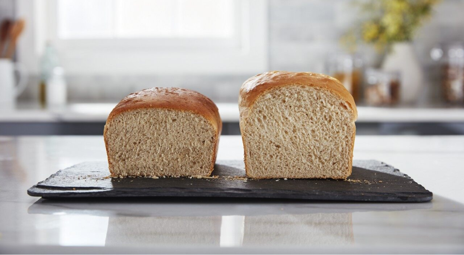 Split loaf of homemade bread on cutting board
