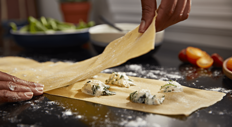 Making homemade ravioli pasta with cheese filling