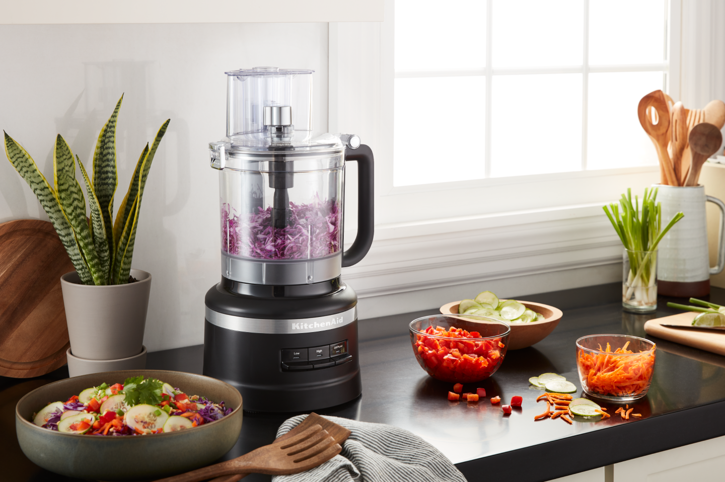 Shredded cabbage inside a black KitchenAid® food processor