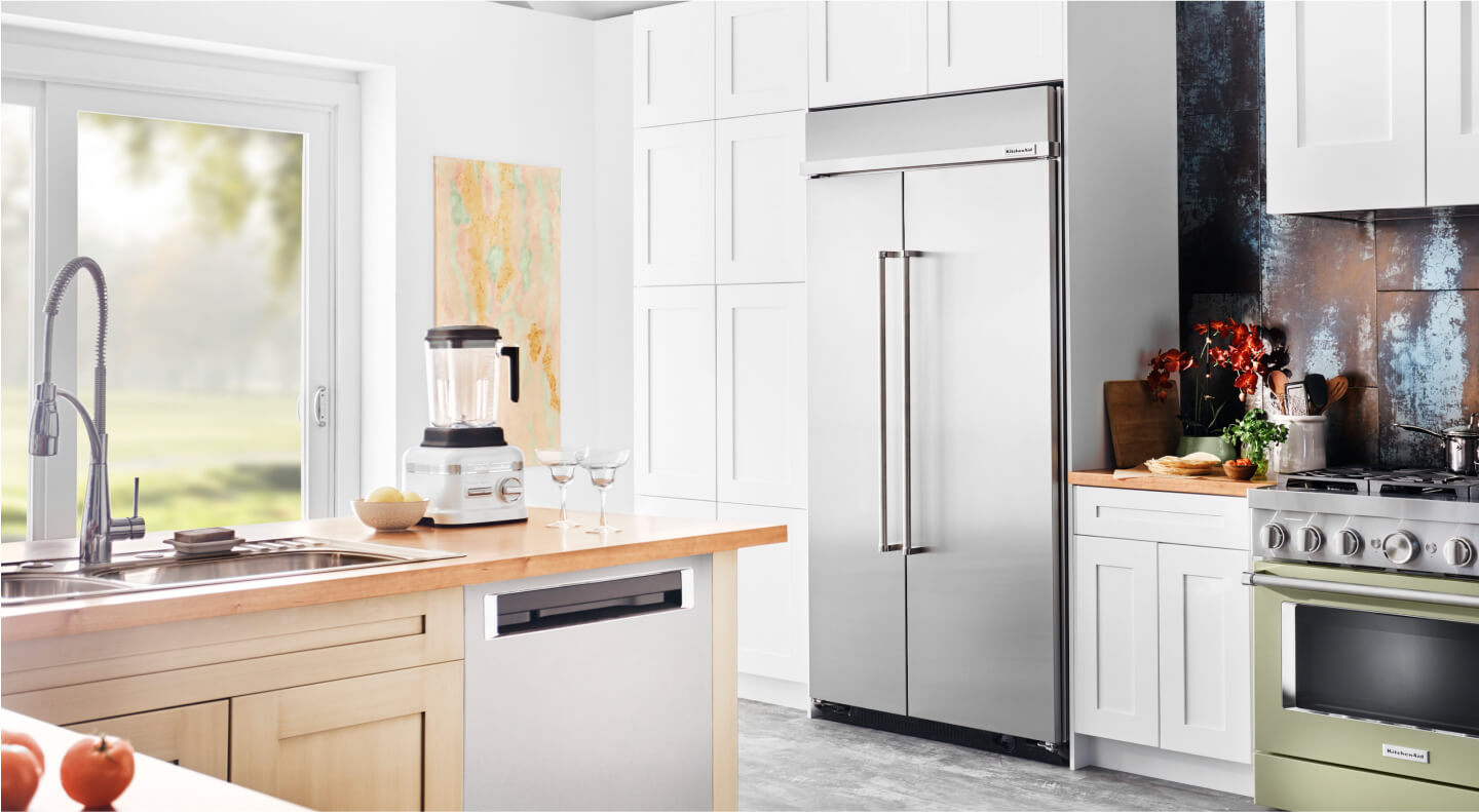 A built-in KitchenAid® refrigerator surrounded by white cabinetry