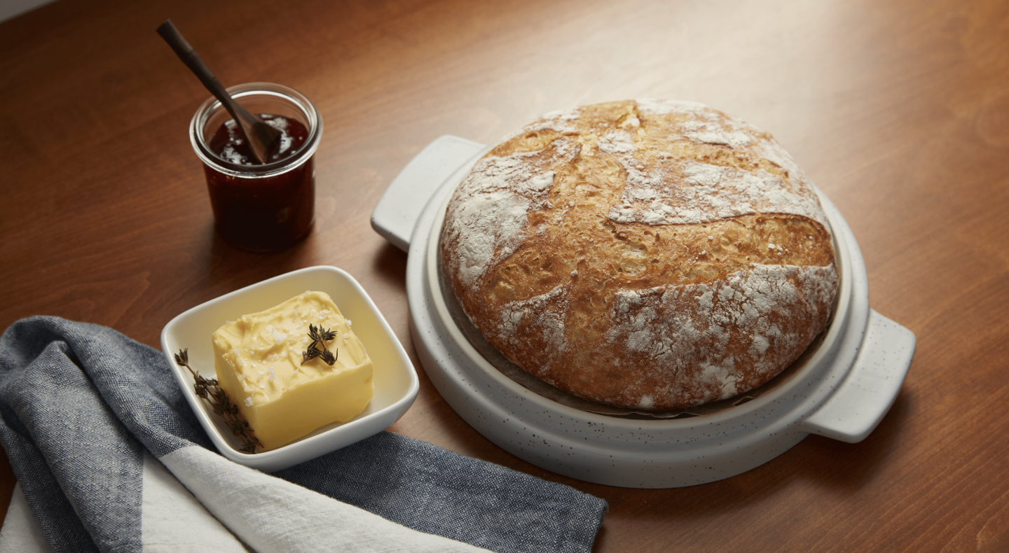 Butter next to bread on a countertop