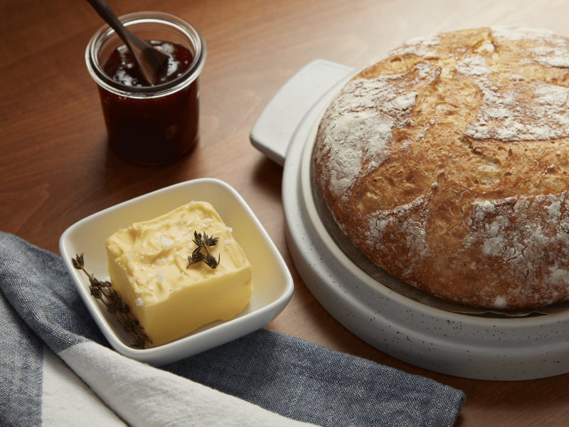 Butter next to bread on a countertop