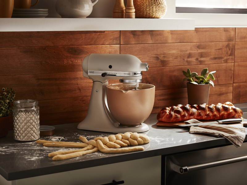 KitchenAid® Stand Mixer with freshly baked challah and challah dough being braided in front of the mixer 