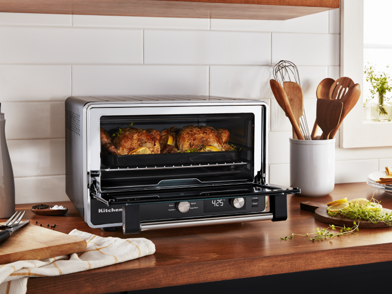 Two whole chickens roasting in a KitchenAid® countertop oven