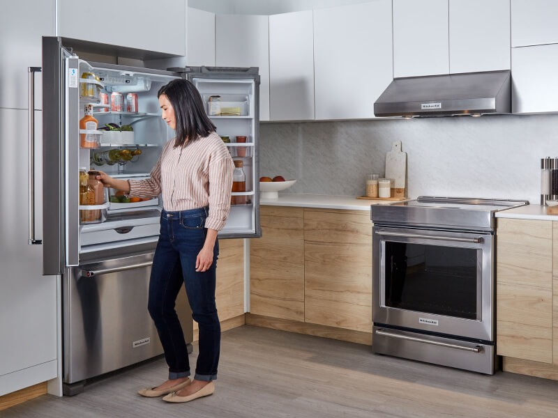 Person looking in KitchenAid® french door refrigerator