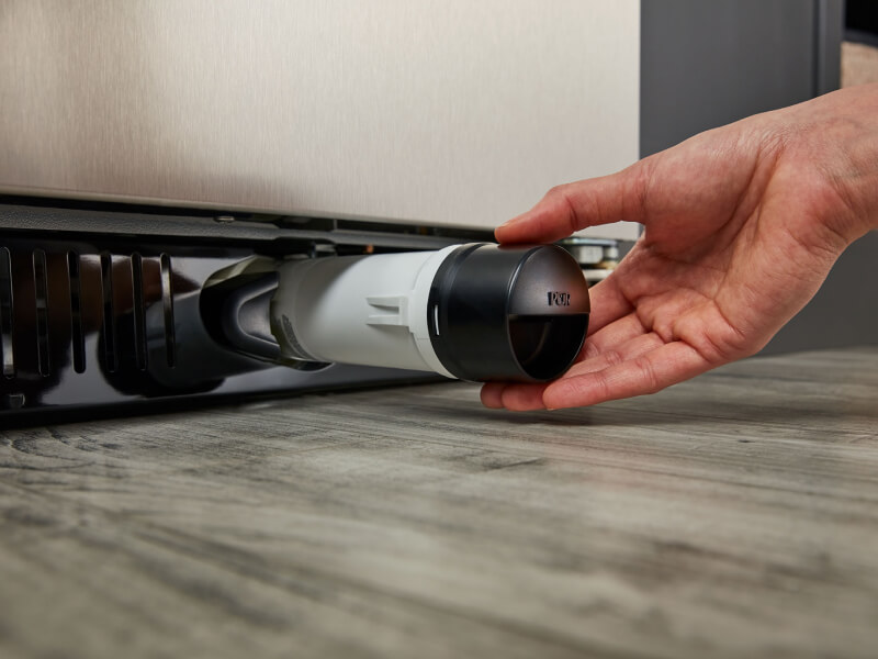 Person removing refrigerator water filter