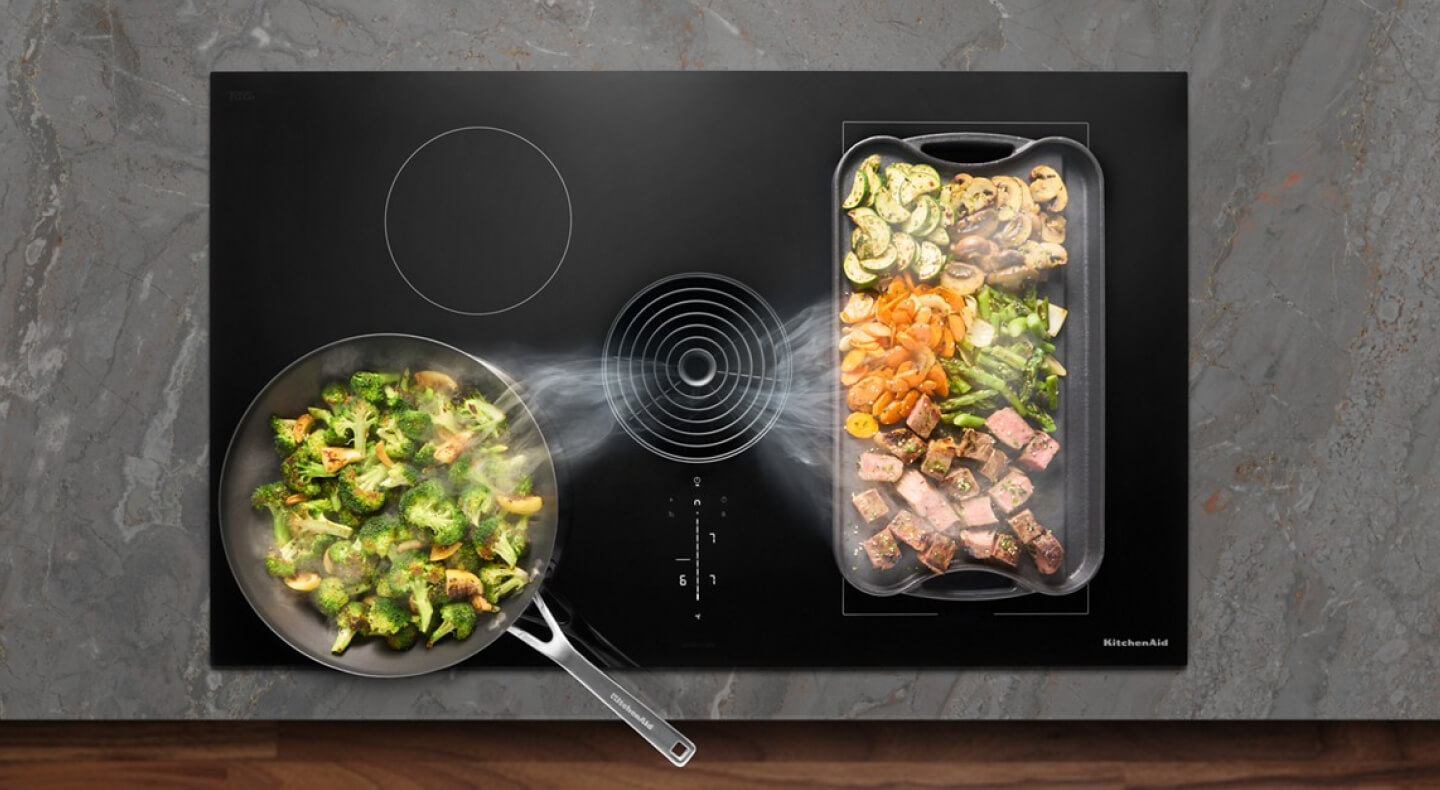 Food cooking on a cooktop with steam rising from it