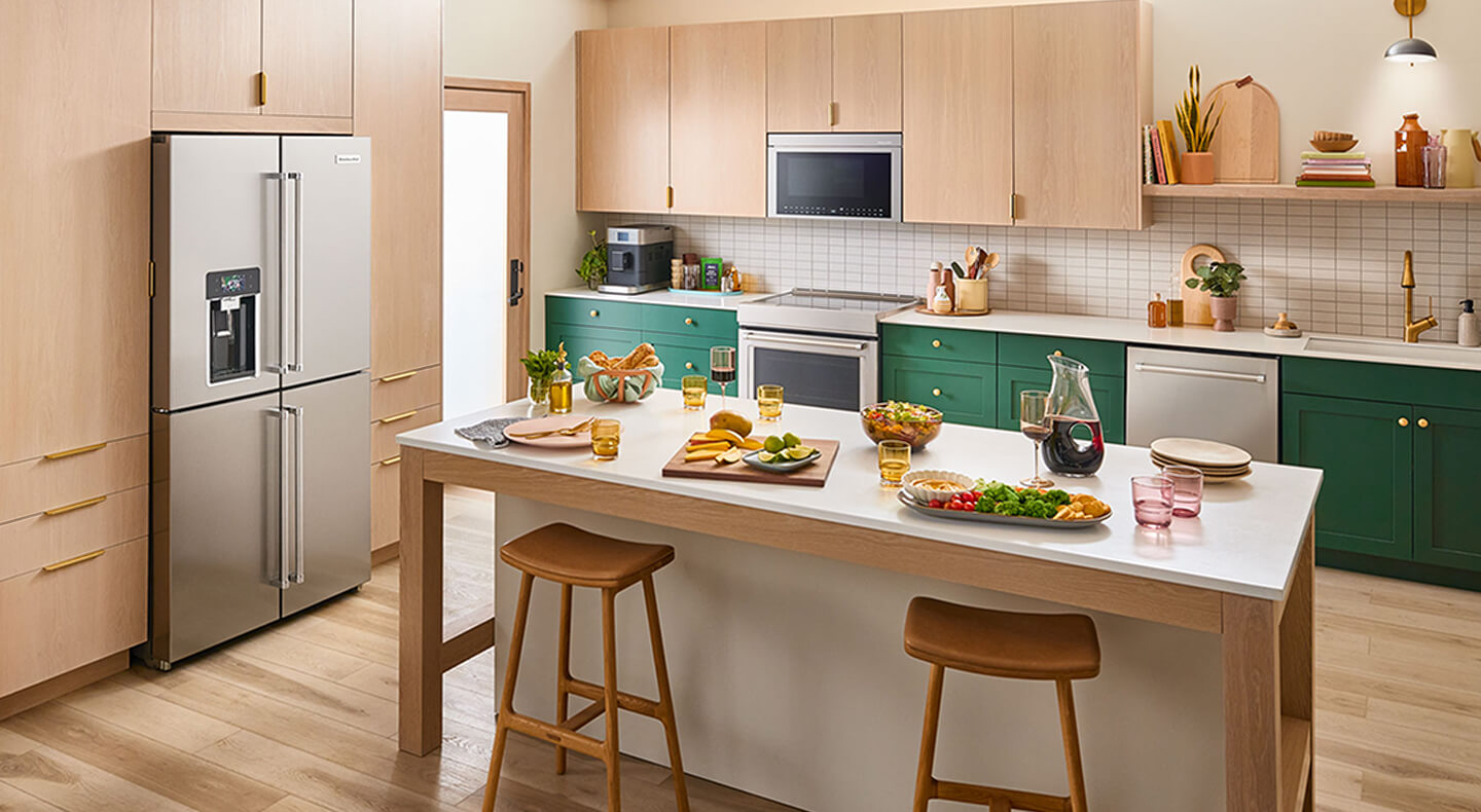 A warm kitchen with light cabinets and a white-topped island