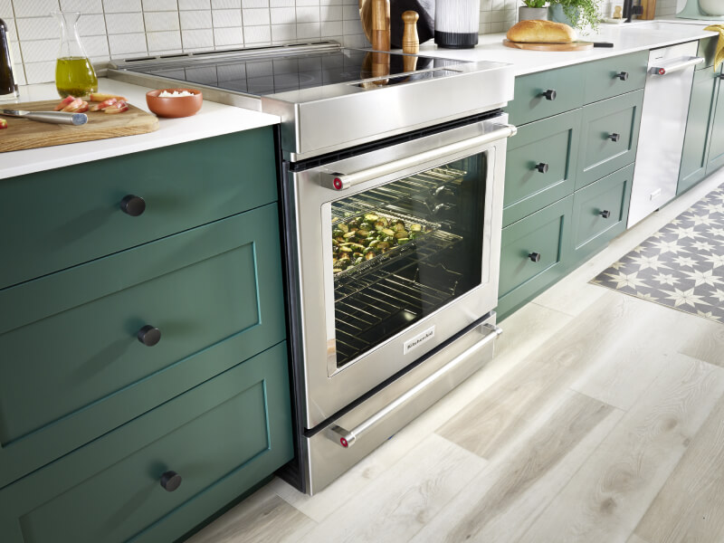 Electric range in a green and white kitchen