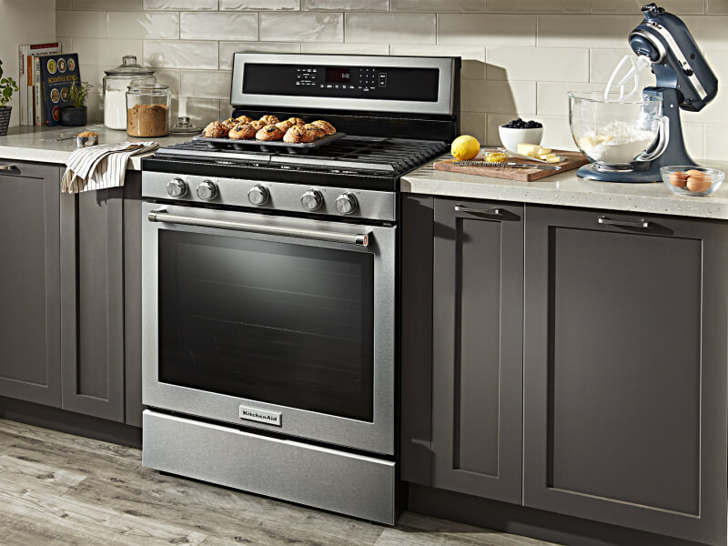 Gas range in a black and white kitchen