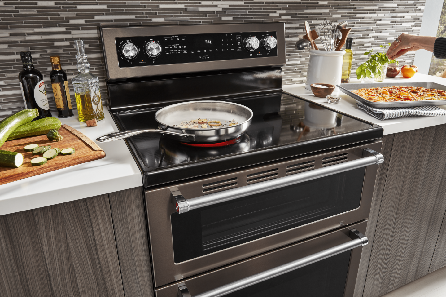 Large skillet cooking food on the electric stovetop of a KitchenAid® double oven range